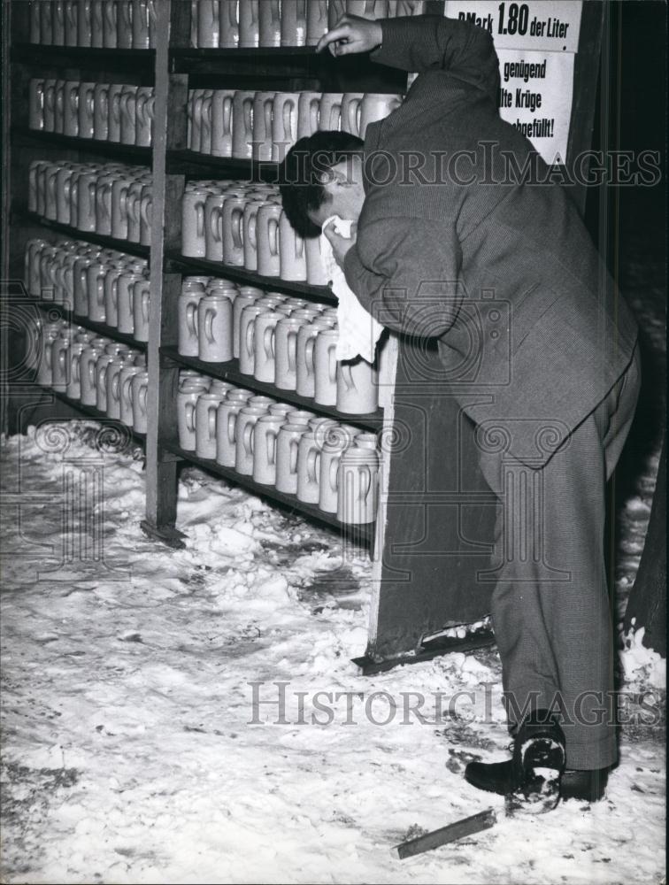 Press Photo Man Bent Over in Storeroom - Historic Images