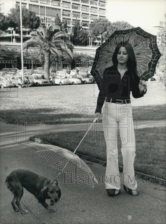 1974 Press Photo Ital Dir Federico Fellini's Niece Maria With Umbrella For Dogs - Historic Images