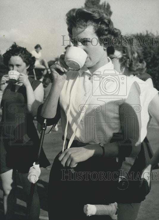 Press Photo Mavis Enjoys a sip of orange juice at half time - Historic Images