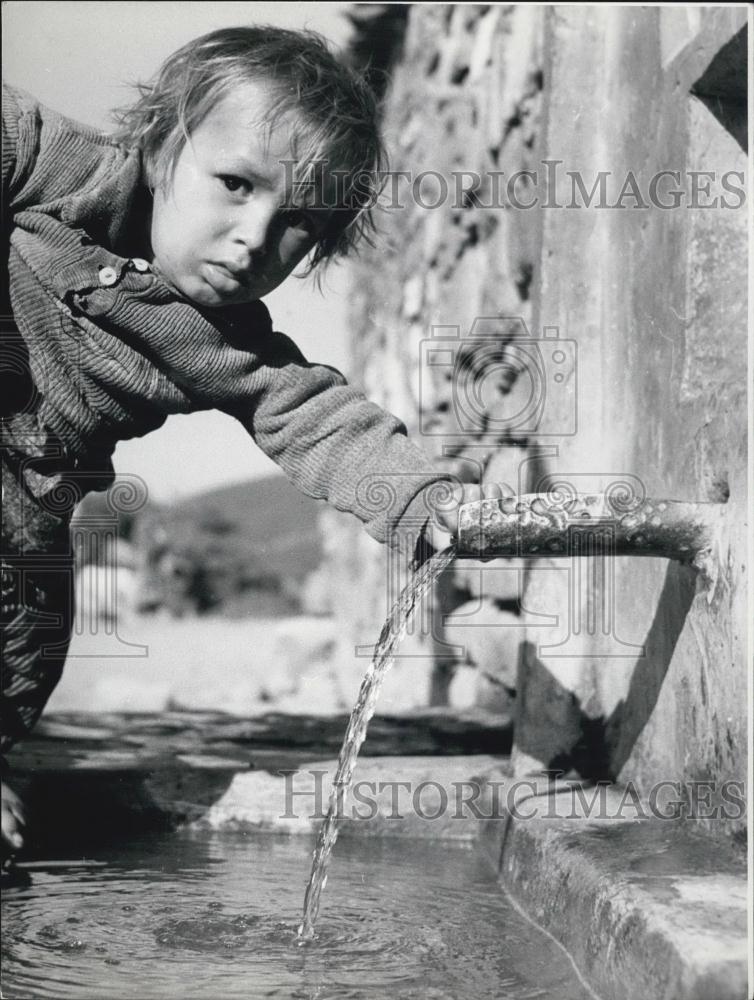 Press Photo Little Boy Plays with Fresh Water from the City Streets - Historic Images