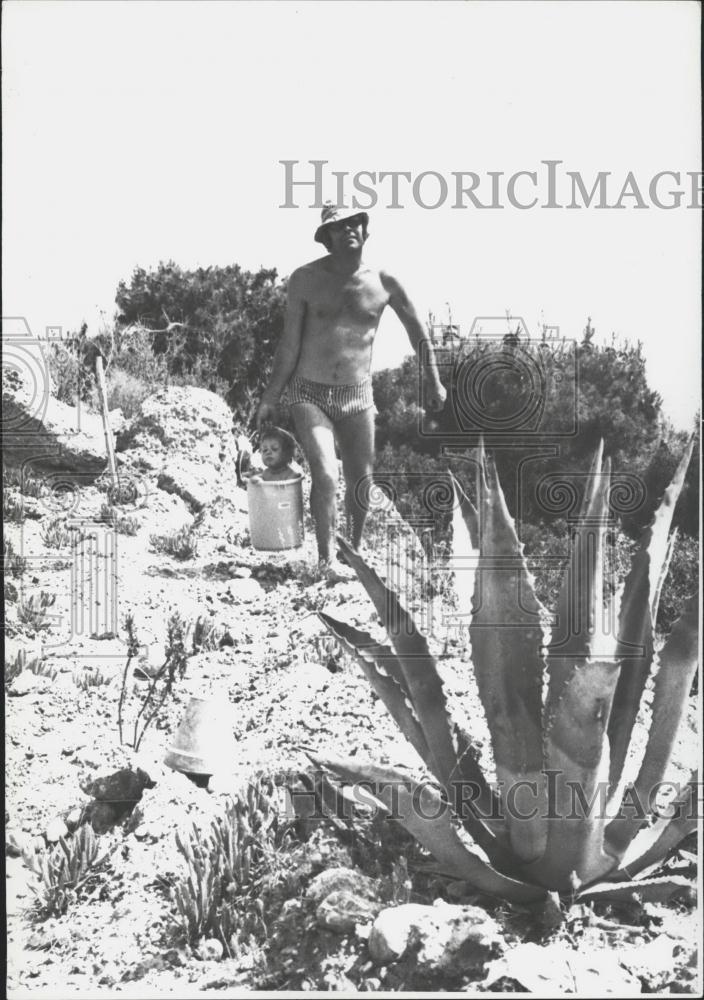 Press Photo Greece man carrying water - Historic Images