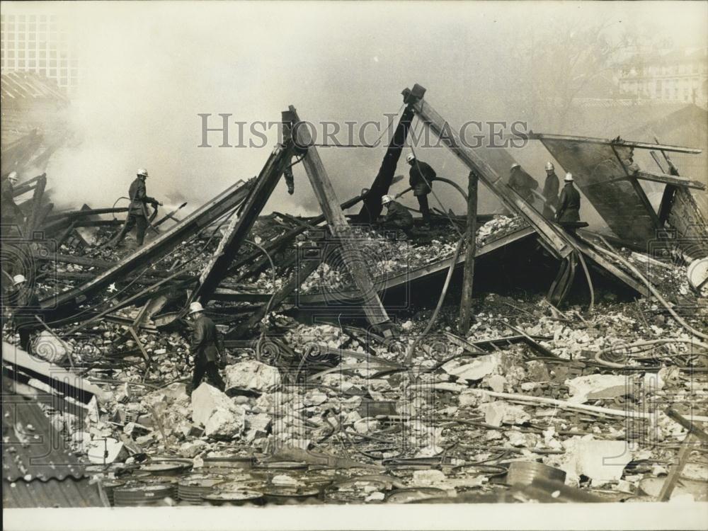 1973 Press Photo Firefighters Walk Amongst Cartridge Factory Ruins After Fire - Historic Images