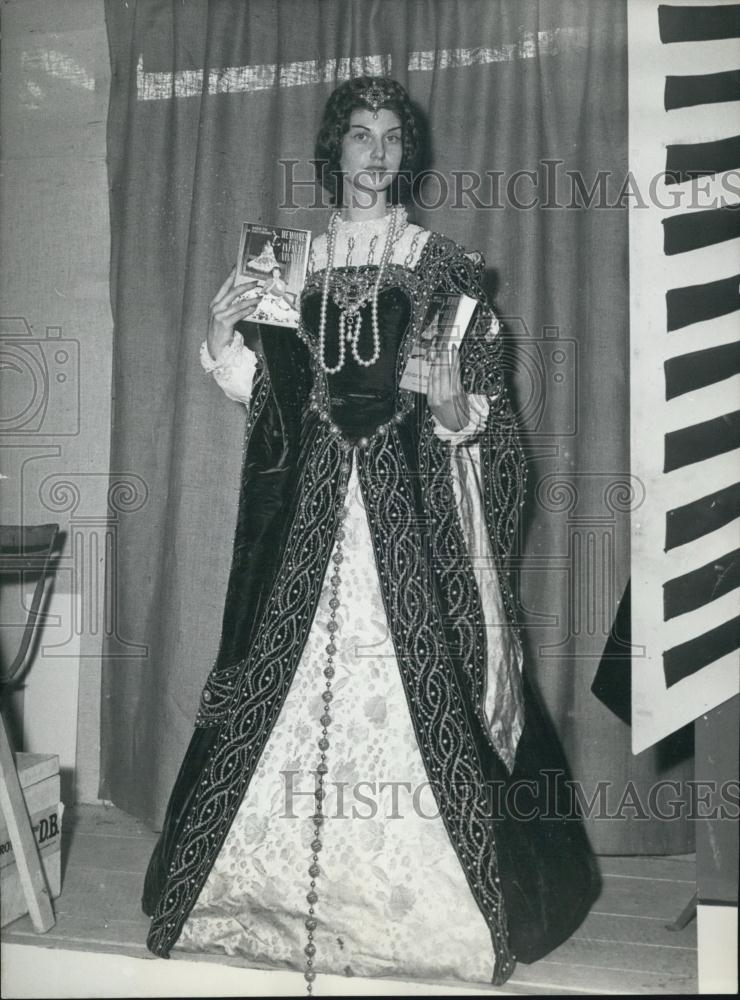 1957 Press Photo Girl in Period Costume Holding Memoirs of a Living Infanta&quot;&quot; - Historic Images