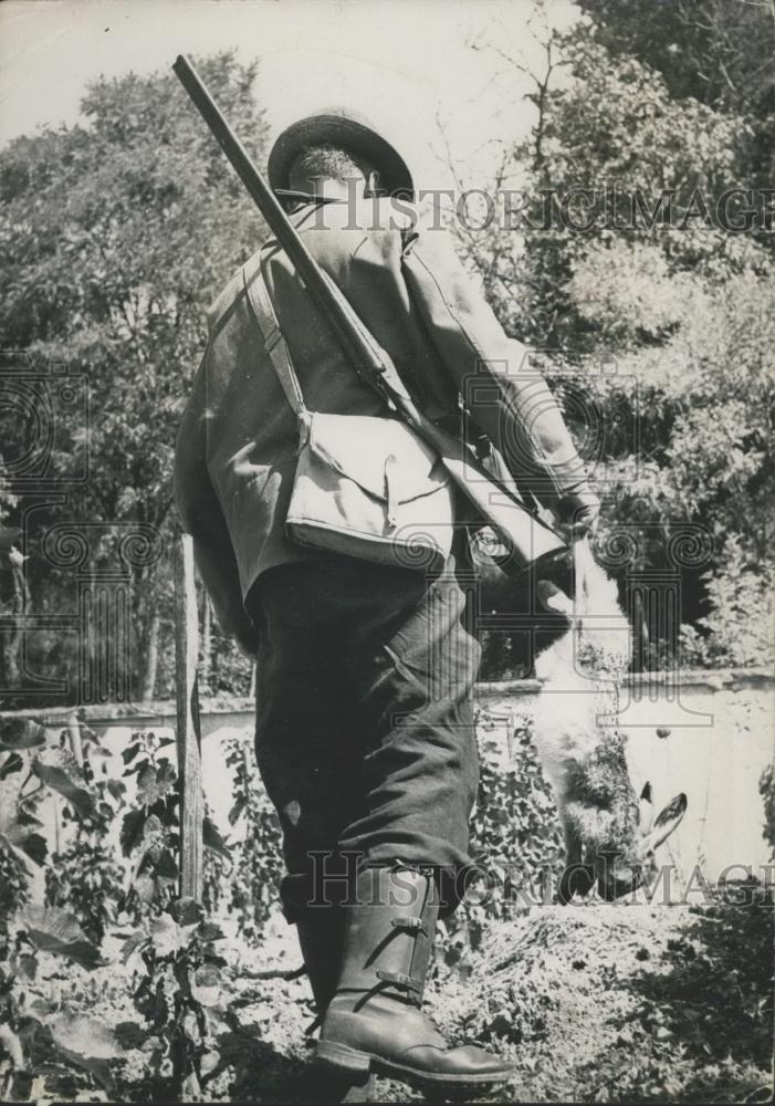 Press Photo Hunter with His Kill, a Rabbit - Historic Images