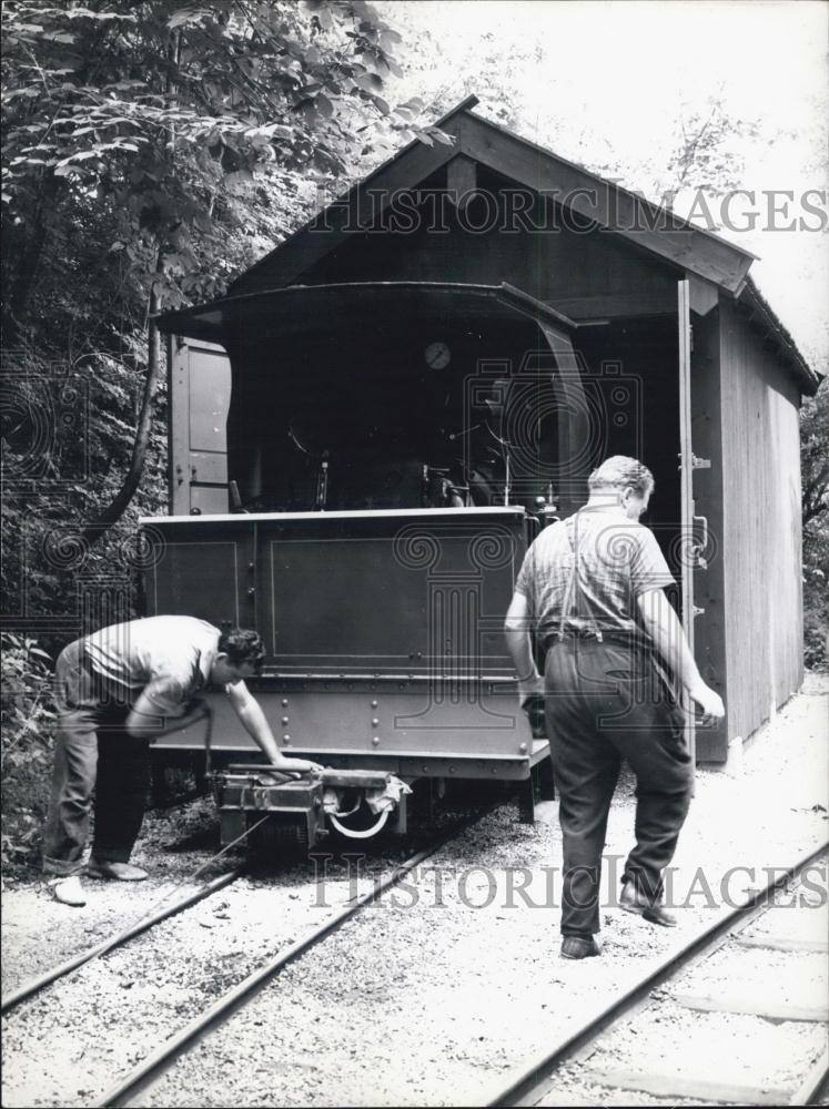 Press Photo Gaisbauer and Assistant Move Locomotive out of Shed - Historic Images