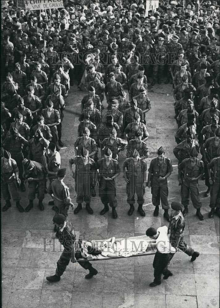 Press Photo A woman who passed out at General De Gaule review in Algiers - Historic Images