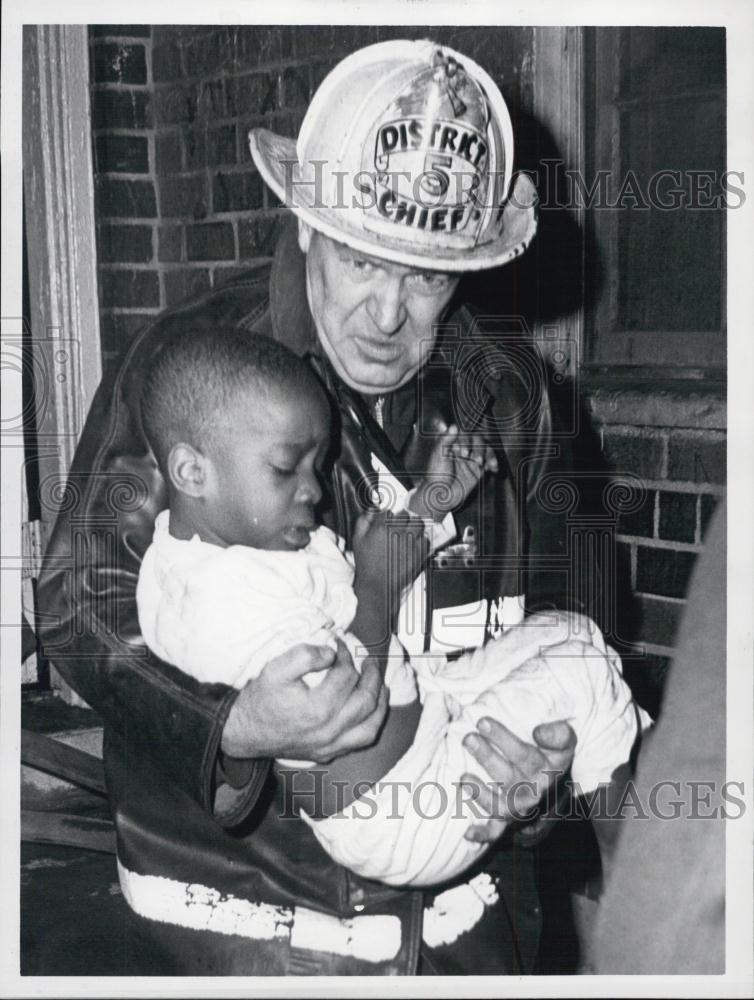 1964 Press Photo Fire Chief John J Collins Rescues Child from Burning Building - Historic Images