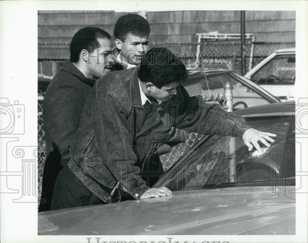 1990 Press Photo friends and relatives look at windshield of shot car Junior - Historic Images