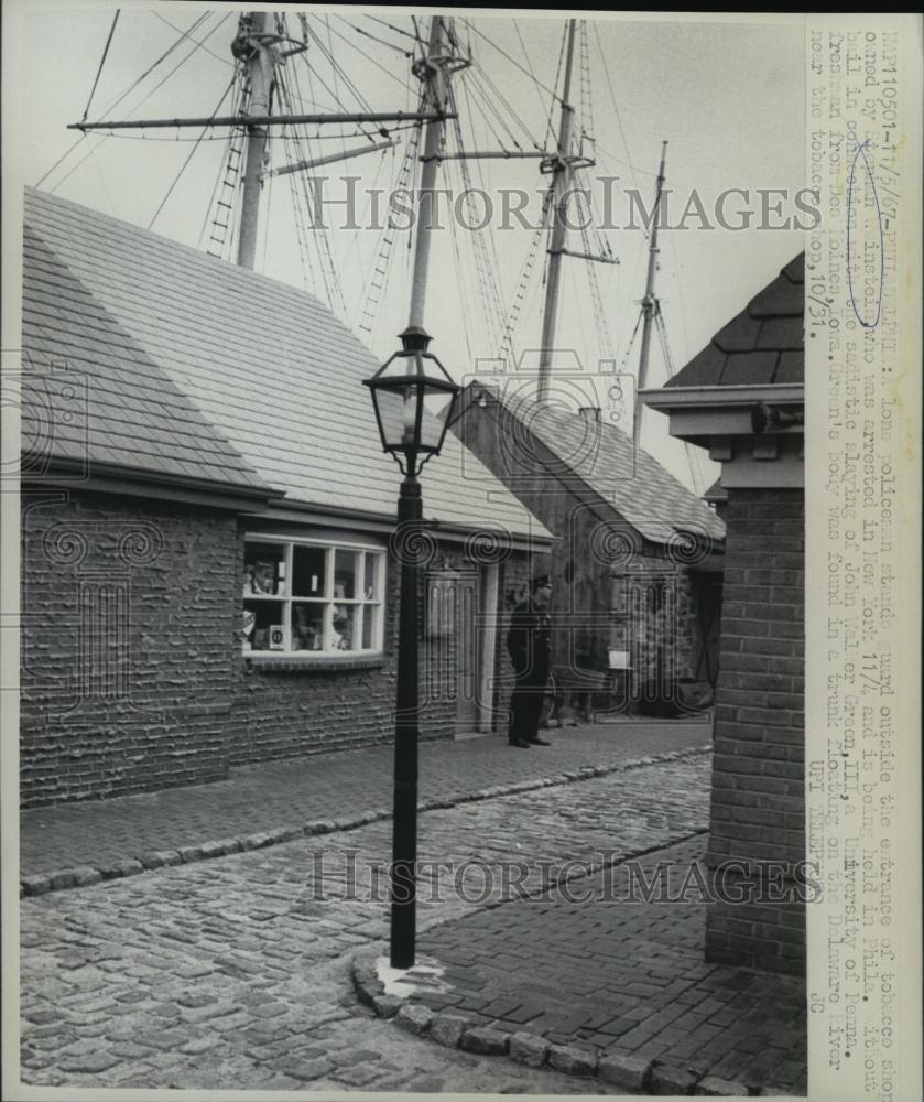 1967 Press Photo Police Officer Standing Guard Outside Tobacco Shop - RSL43311 - Historic Images