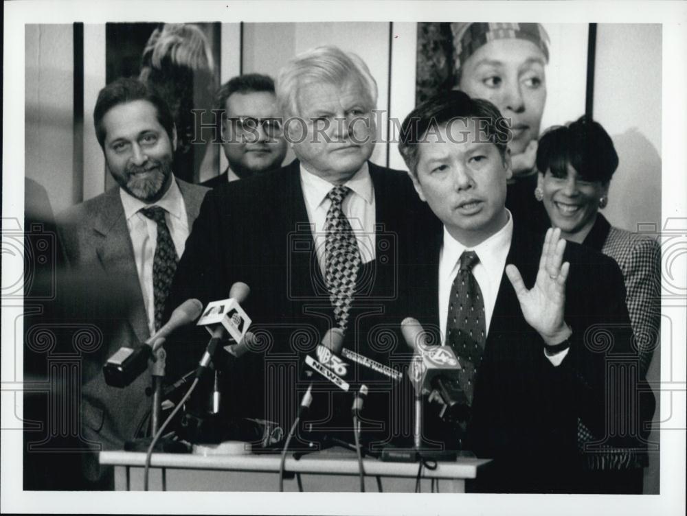1997 Press Photo Paul Lee speaks to media as Senator Ted Kennedy looks on - Historic Images