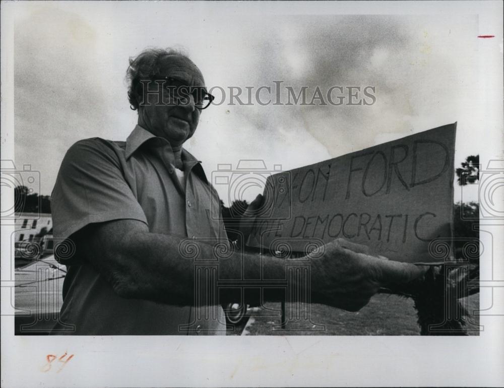 1976 Press Photo Merton Miller &amp; a campaign bumper sticker - RSL98757 - Historic Images