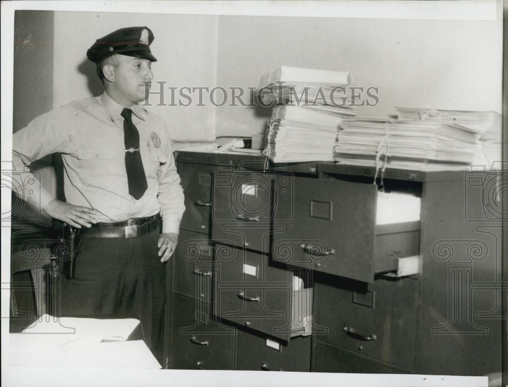 1956 Press Photo Patrolman Ray Celona officer guards evidence in DA Garrett - Historic Images