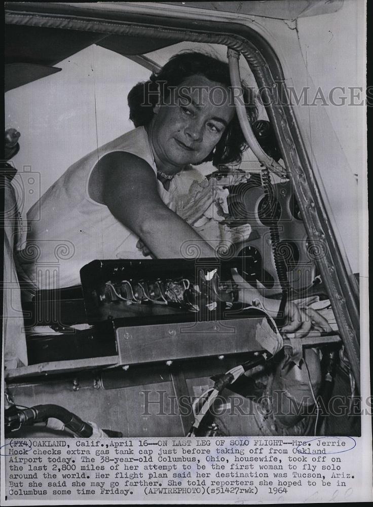 1964 Press Photo Mrs Jerry Mock checks gas cap Oakland Airport - RSL82091 - Historic Images