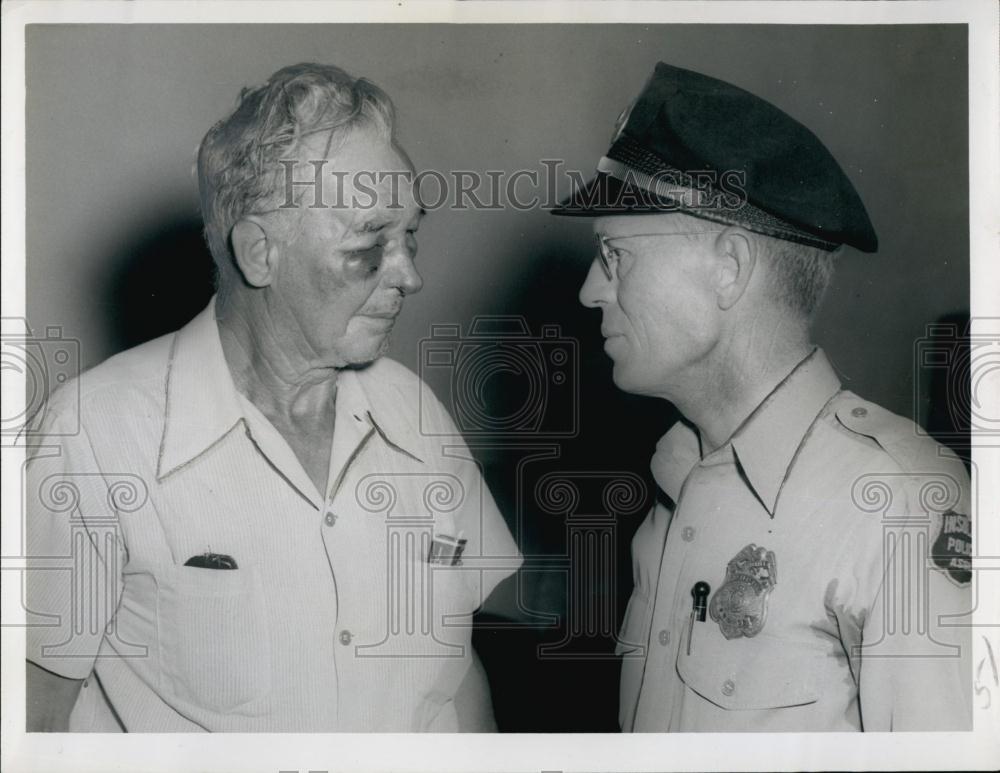 1952 Press Photo Police Officer Looks at Man with Black Eye - RSL67179 - Historic Images