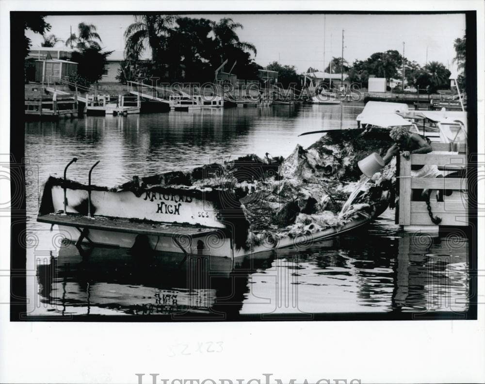 William Hughes and his burnt up boat at Florida dock - RSL68983 - Historic Images