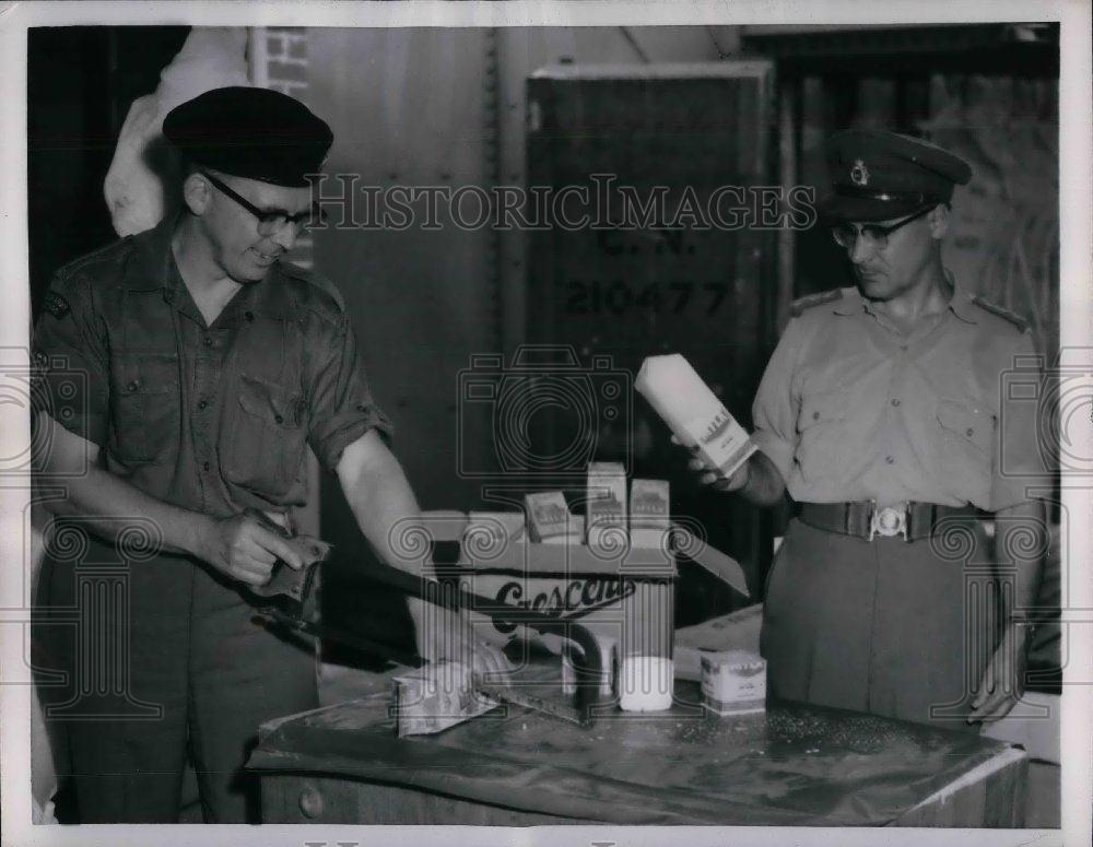 1957 Press Photo Capt. Mike Eikle hold a bock of ice-milk for Canadian. - Historic Images