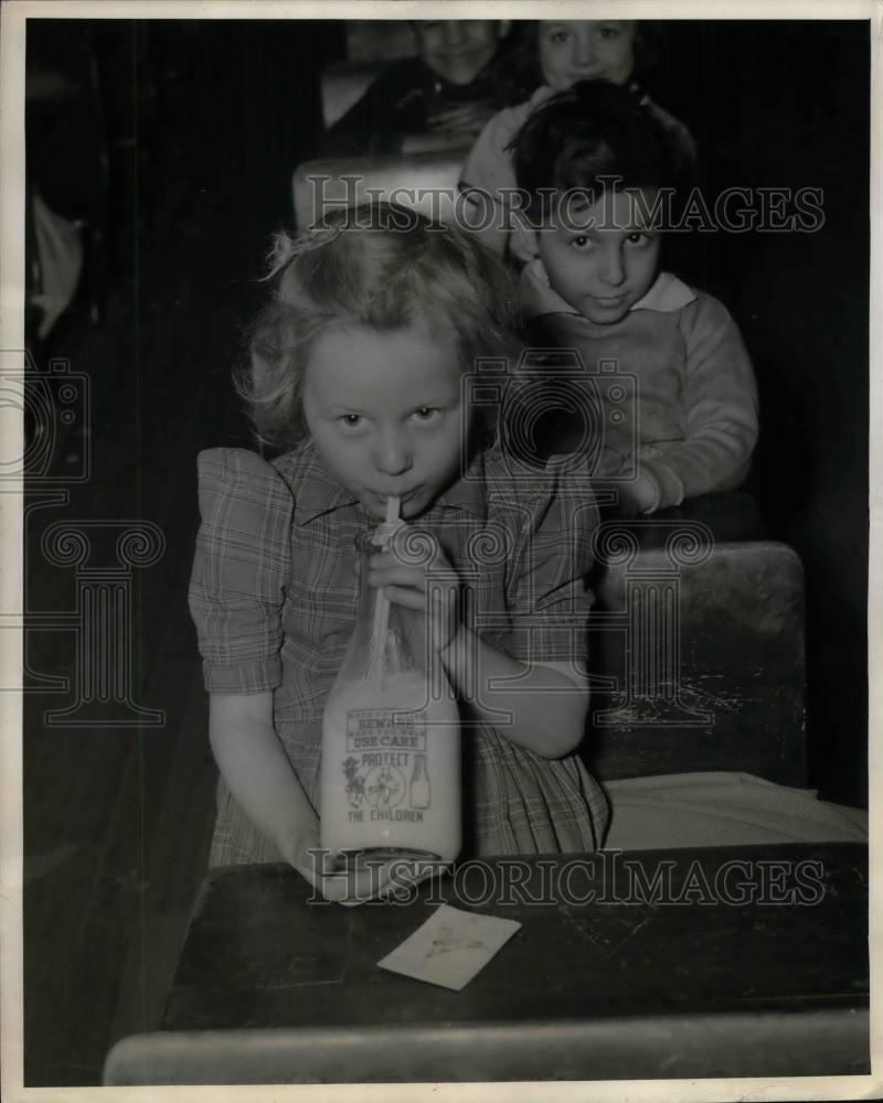 1941 Press Photo Safe Glass of Milk Bottles drink by Little Janet Burgoyne. - Historic Images