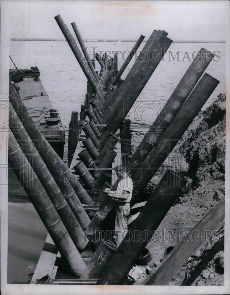 1956 Press Photo Dock Construction 80 foot cylindrical pipes driven in Lake Erie - Historic Images