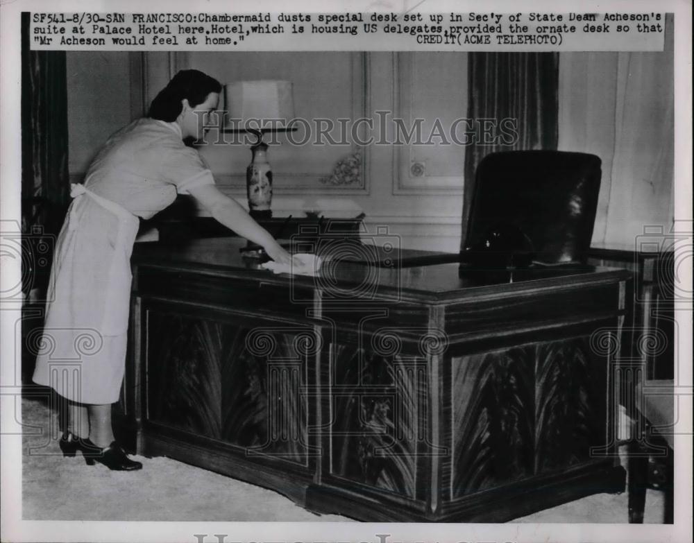 1951 Press Photo Chambermaid dusts desk in Dean Acheson's suite, Palace Hotel - Historic Images