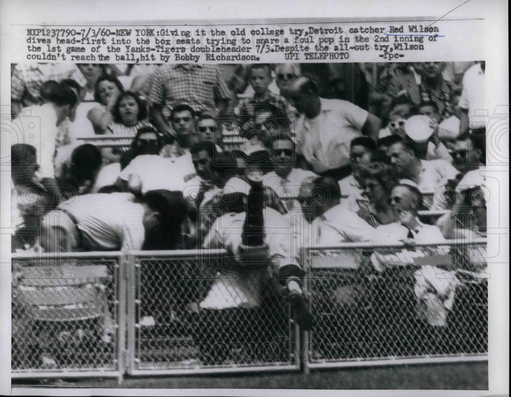 1960 Press Photo Tigers catcher ed Wilson dives into box seats - Historic Images