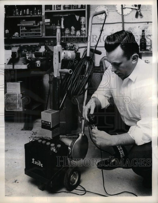 Press Photo Lawn Trimmer plugging into Charger yard Maintenence - nea26236 - Historic Images