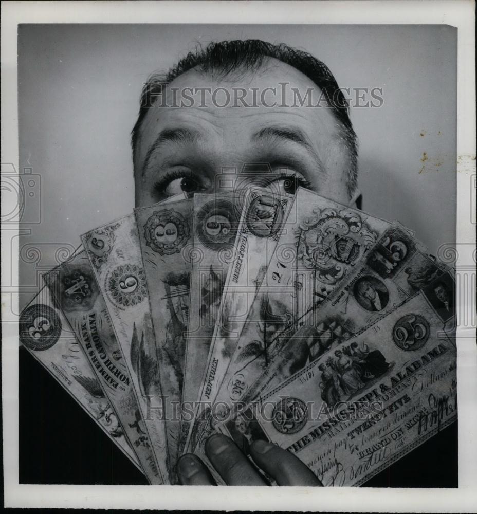 1962 Press Photo David McClymont Holds Bills Thought Phony - nea23976 - Historic Images