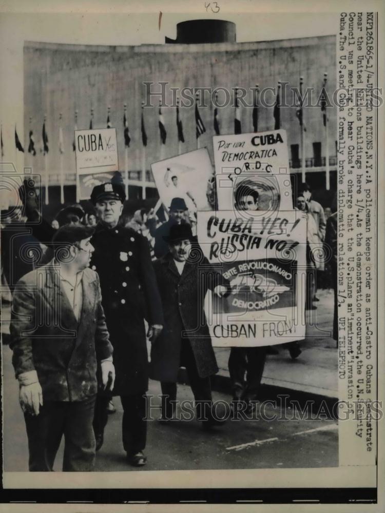 1961 Press Photo Policeman keeps order as anti-Castro Cubans demonstrate near - Historic Images