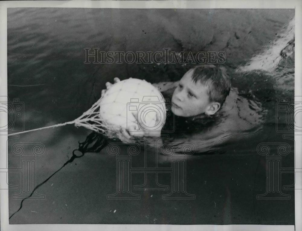 1961 Press Photo Youngster Demonstrates Life Saving Ball - nea32777 - Historic Images
