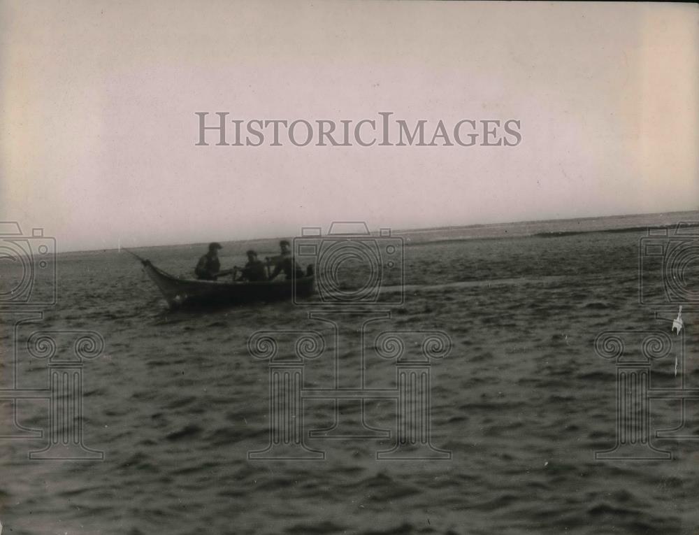 1923 Press Photo Two men paddle a boat while other man spear fishes - nea30453 - Historic Images