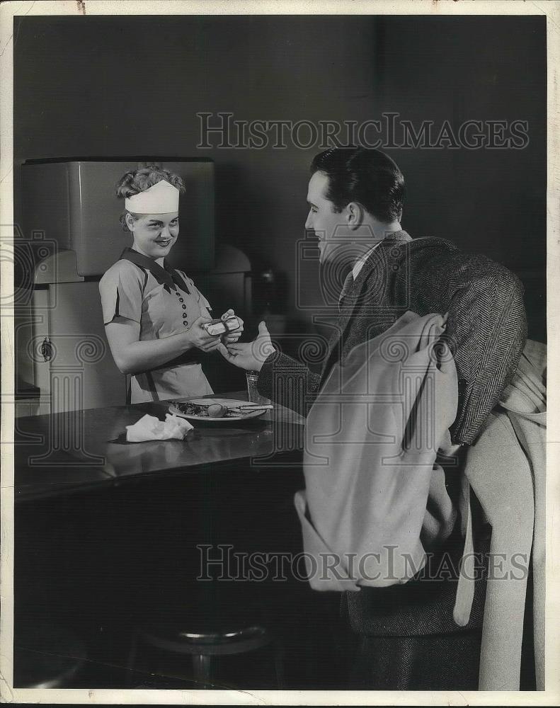 1942 Press Photo Man in suite receiving a gift from a lady - nea38550 - Historic Images