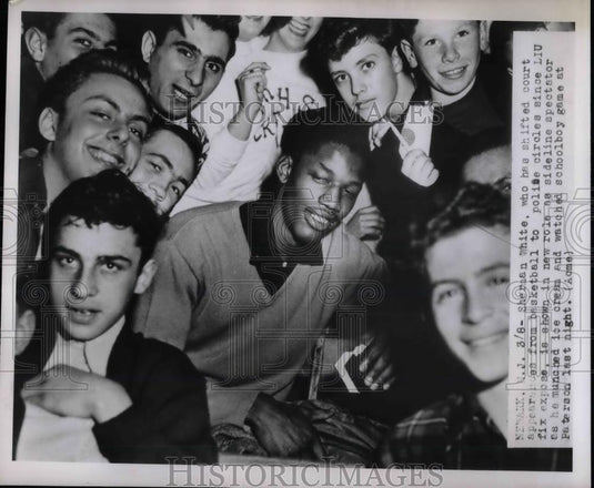 1951 Press Photo Sherman White Watches Basketball Game From Stands With Friends - Historic Images