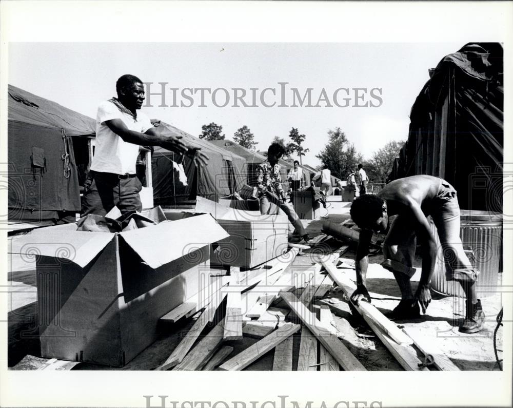 Press Photo Cuban refugees clean up the area in the Tent City - Historic Images