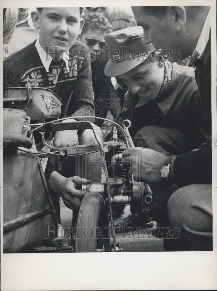 Press Photo Small race bike and dad checking it over - Historic Images