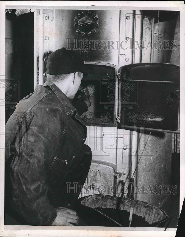 1955 Press Photo Man Sweeping Loose Soot From Furnace - nea90855 - Historic Images