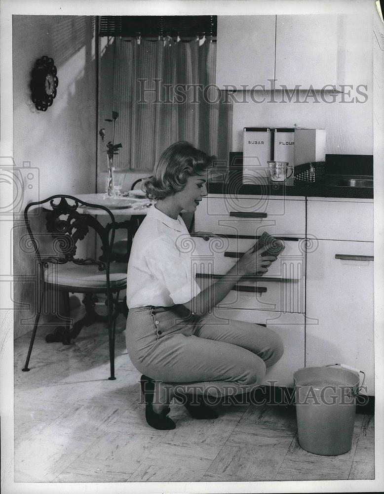 1958 Press Photo A homemaker cleaning kitchen cabinets - nea82177 - Historic Images