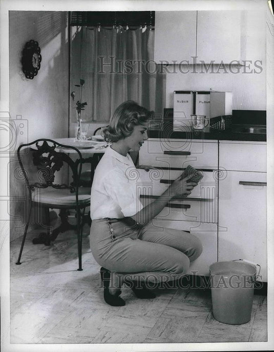 1958 Press Photo A homemaker cleaning kitchen cabinets - nea82177 - Historic Images