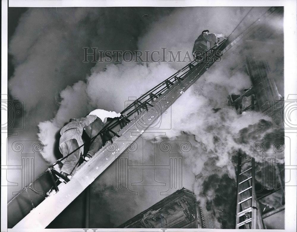 1955 Press Photo Two firemen assisting residents of comfort Hotel - nea89722 - Historic Images