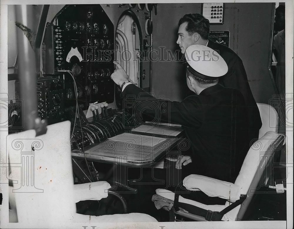 1939 Press Photo Men Looking At Control Boards &amp; Sitting In Chair - nea95022 - Historic Images