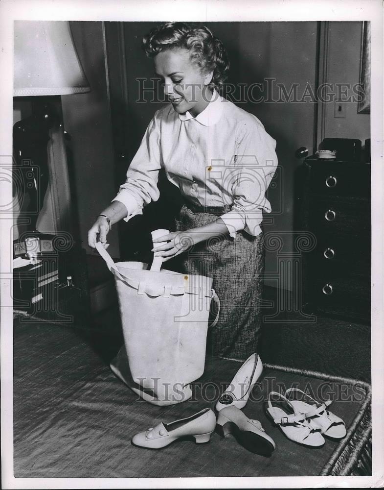 1954 Press Photo A woman packing shoes in a new type storage bag - nea89204 - Historic Images