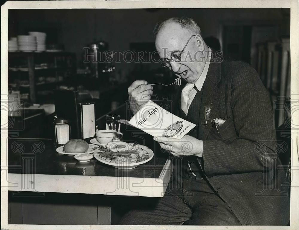 1938 Press Photo D.H. Rathbobe Eating ham &amp; eggs - Historic Images