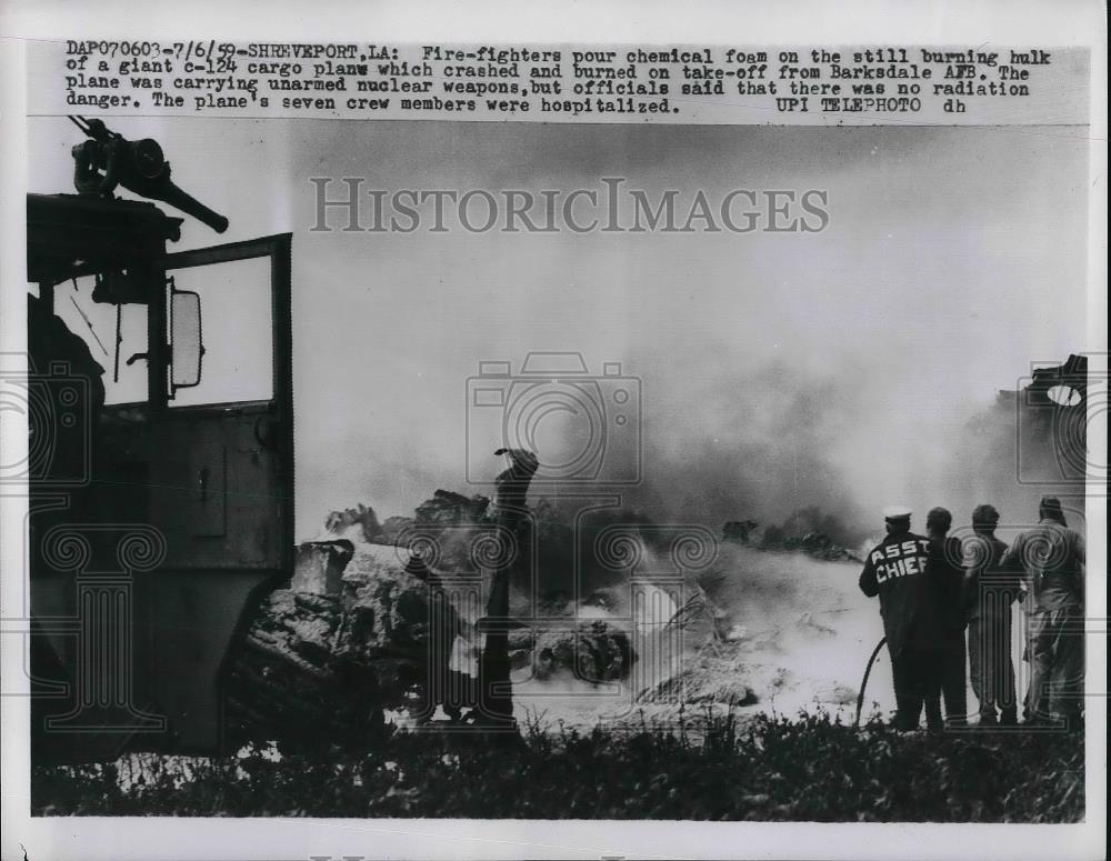 1959 Press Photo Fire-fighters pour chemical foam on the still burning hulk of a - Historic Images