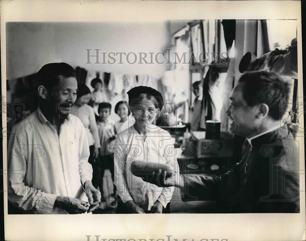 Press Photo Tran Van Khue and Wife, Refugees with a Priest in Saigon - neb15297 - Historic Images