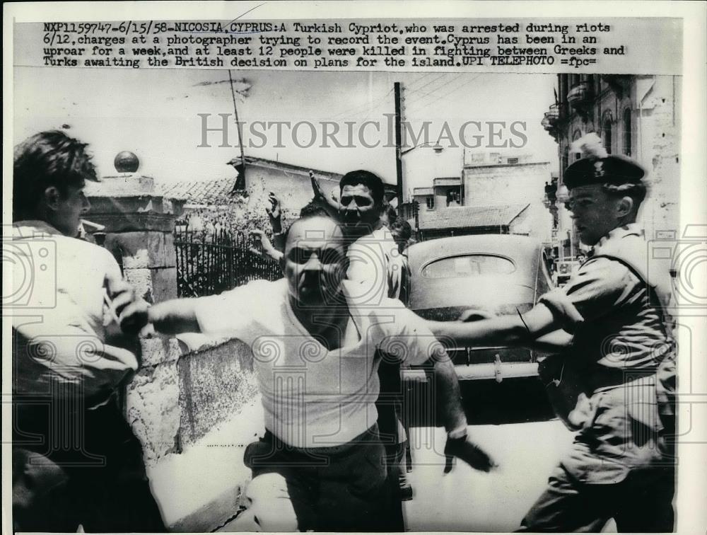 1958 Press Photo Turkish Cypriot arrested in riots charges at news photographer - Historic Images