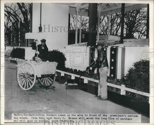 Press Photo Workers clean up in front of the president's podium. - neb18273 - Historic Images