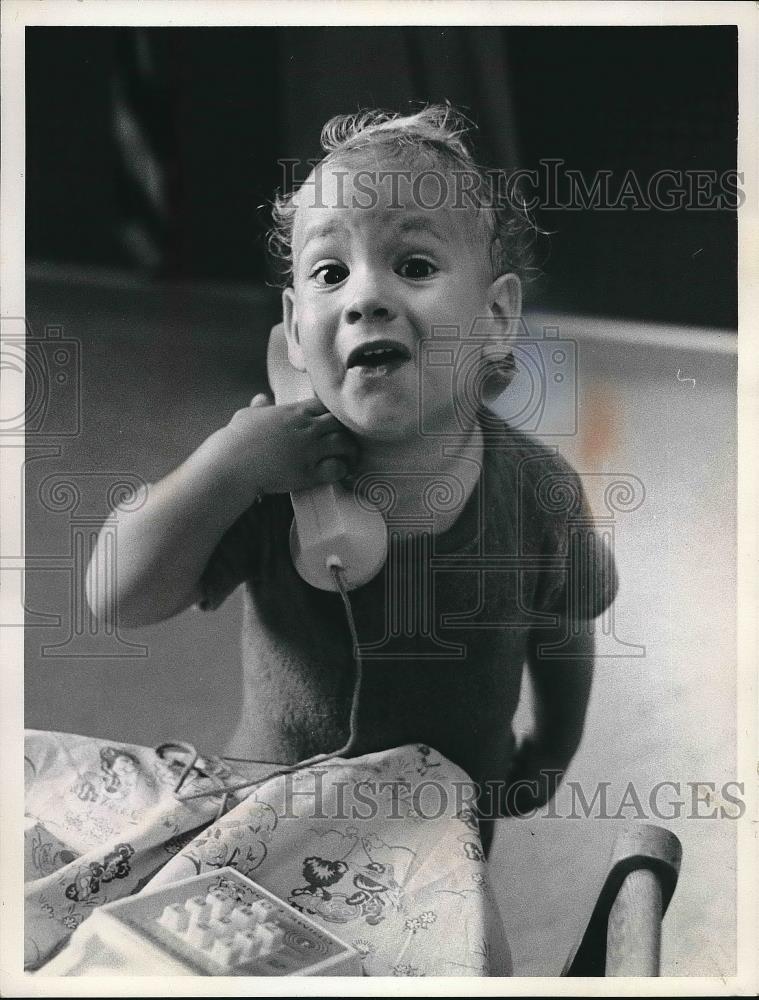1973 Press Photo Jimmy McGrath, Child on Phone - nea97304 - Historic Images