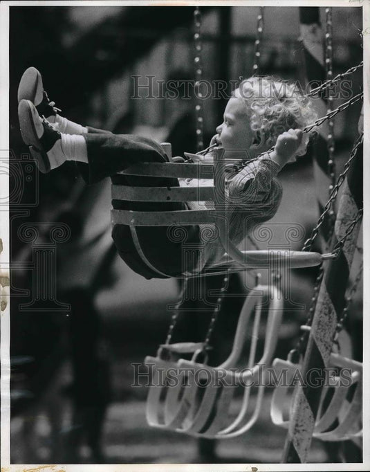 1971 Press Photo Toddler sits on a swing to play in Omaha, Nebraska - Historic Images