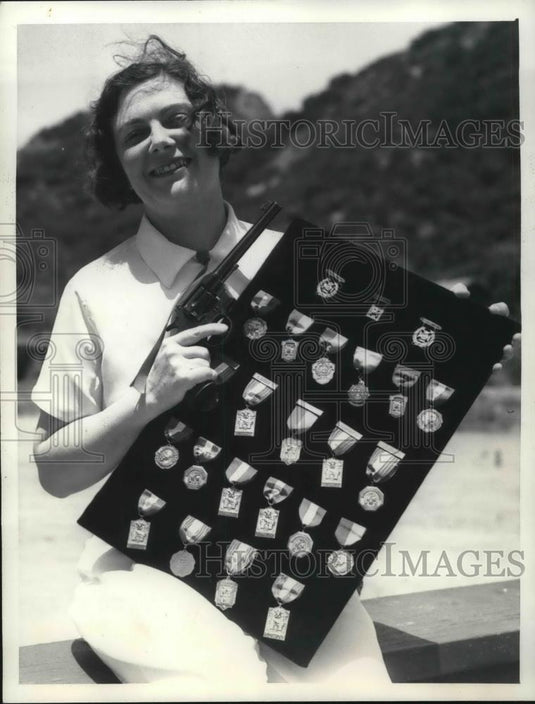 1935 Press Photo Miss Bobby Rutherford with awards she won in pistol matches - Historic Images