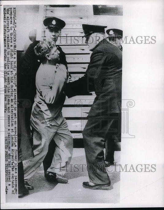 1954 Press Photo "Bobby" Has Arm Lock on Passenger at London Airport - Historic Images