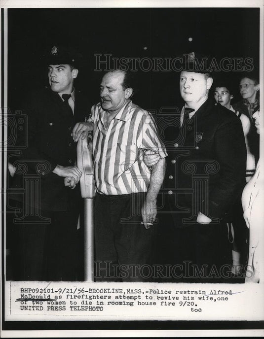 1956 Press Photo Police Restrain Alfred McDonald as Firefighters Revive His Wife - Historic Images