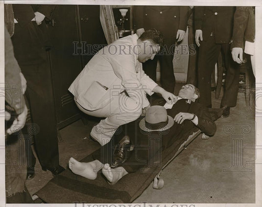 1938 Press Photo Doctor attending J.Statcher a PWA worker in a stretcher. - Historic Images